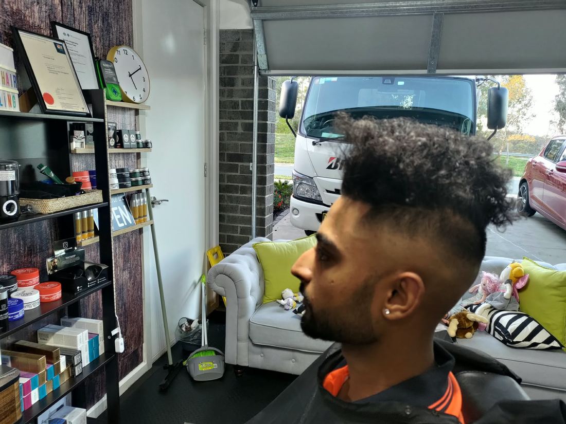 Curly top with a high skin fade